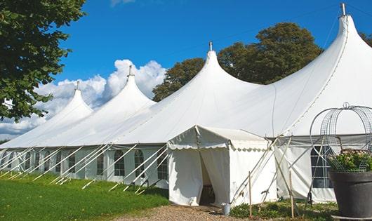 a line of portable restrooms in a shaded area, offering a comfortable experience for users in Brighton, MA